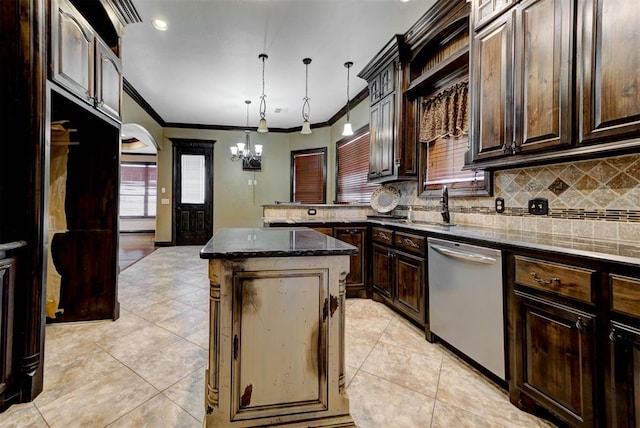 kitchen featuring dark stone countertops, a kitchen island, decorative backsplash, dishwasher, and a chandelier