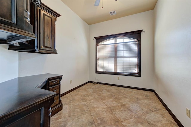 interior space with visible vents, dark countertops, dark brown cabinetry, baseboards, and ceiling fan