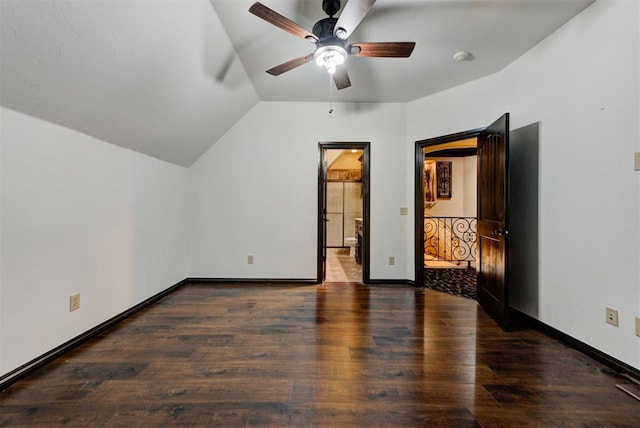 unfurnished bedroom with vaulted ceiling, wood finished floors, baseboards, and connected bathroom