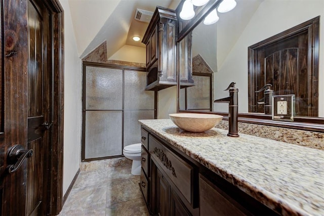 full bath with a shower with door, visible vents, toilet, vaulted ceiling, and vanity