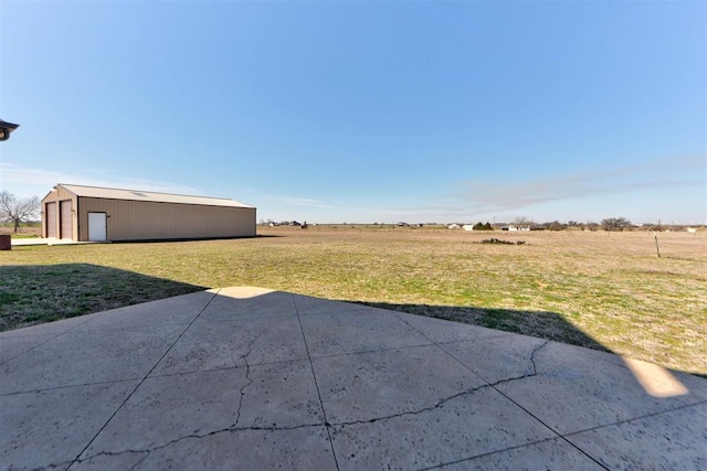 view of yard with a garage, an outbuilding, and a pole building