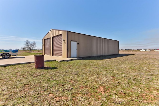 view of pole building with a yard