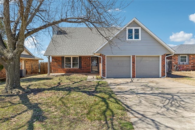 view of front of house featuring fence, driveway, an attached garage, a front lawn, and brick siding