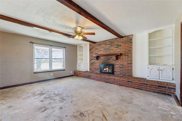 unfurnished living room featuring built in shelves, beam ceiling, a ceiling fan, a fireplace, and baseboards