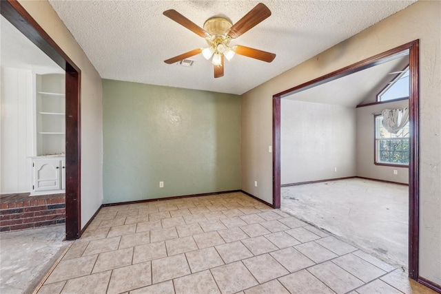 spare room with baseboards, a textured ceiling, lofted ceiling, and ceiling fan