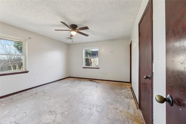 unfurnished bedroom with visible vents, concrete floors, baseboards, a textured ceiling, and a ceiling fan