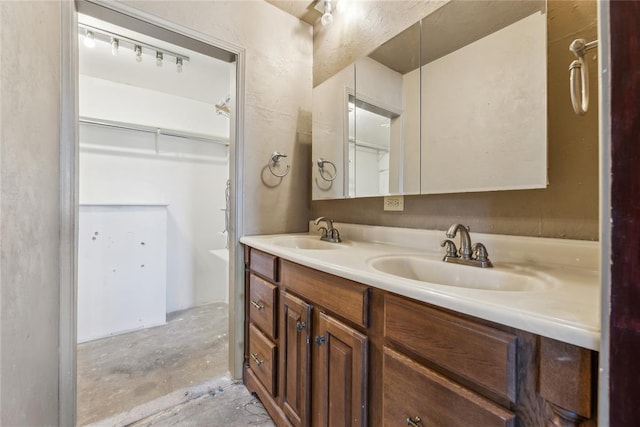 bathroom with a sink, concrete flooring, and double vanity