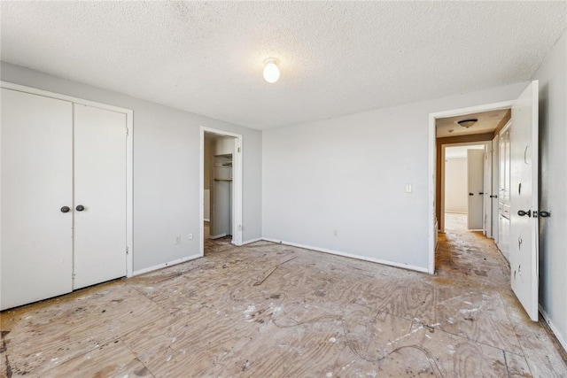 unfurnished bedroom featuring a closet and a textured ceiling