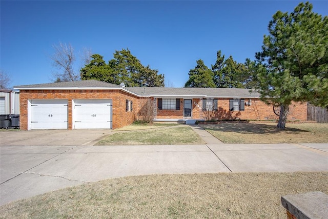 ranch-style house featuring brick siding, a front lawn, concrete driveway, and a garage