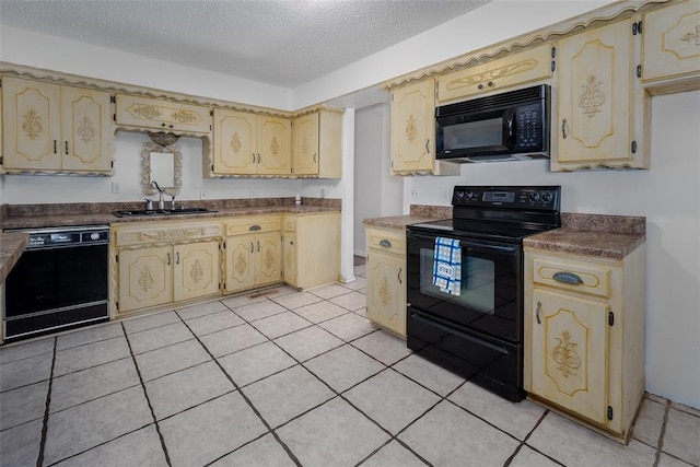 kitchen with a textured ceiling, black appliances, dark countertops, and a sink