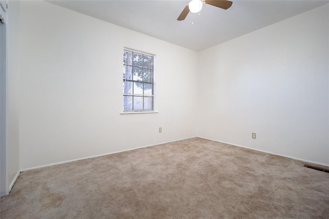 spare room featuring visible vents, carpet flooring, and a ceiling fan