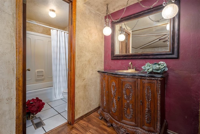 bathroom with visible vents, shower / bath combo with shower curtain, toilet, wood finished floors, and vanity