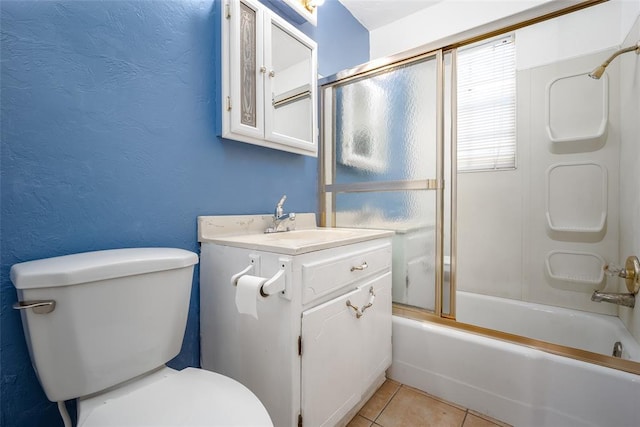 full bathroom with toilet, a textured wall, tile patterned floors, shower / bath combination with glass door, and vanity