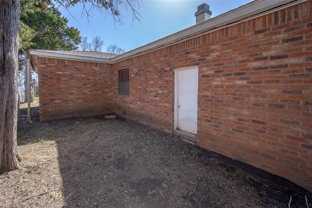 view of side of property with brick siding