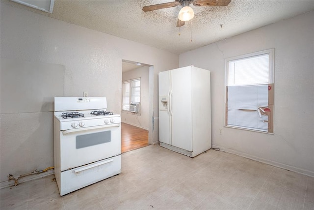 kitchen with white appliances, light floors, a wealth of natural light, and a textured ceiling