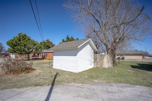 garage with a storage shed and fence