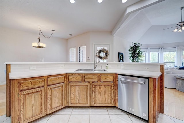 kitchen featuring a ceiling fan, a sink, stainless steel dishwasher, open floor plan, and light countertops