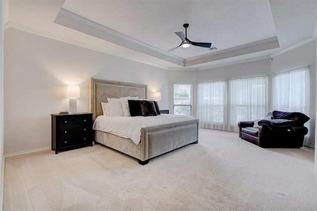 carpeted bedroom featuring visible vents, ornamental molding, a ceiling fan, a tray ceiling, and baseboards