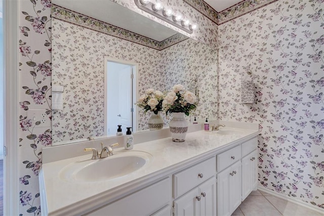 full bath featuring a sink, wallpapered walls, double vanity, and tile patterned flooring