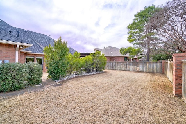 view of yard with a fenced backyard