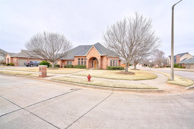 view of front of house with brick siding and driveway