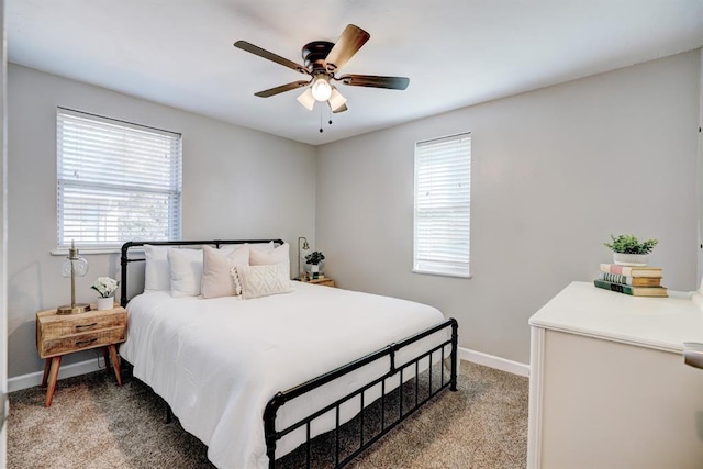 bedroom featuring baseboards, light carpet, and a ceiling fan