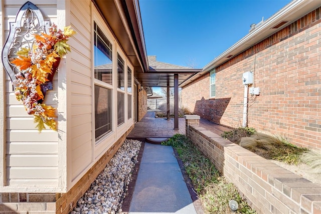 view of side of home with brick siding