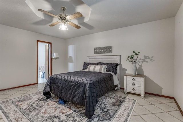 bedroom featuring light tile patterned floors, baseboards, and ceiling fan