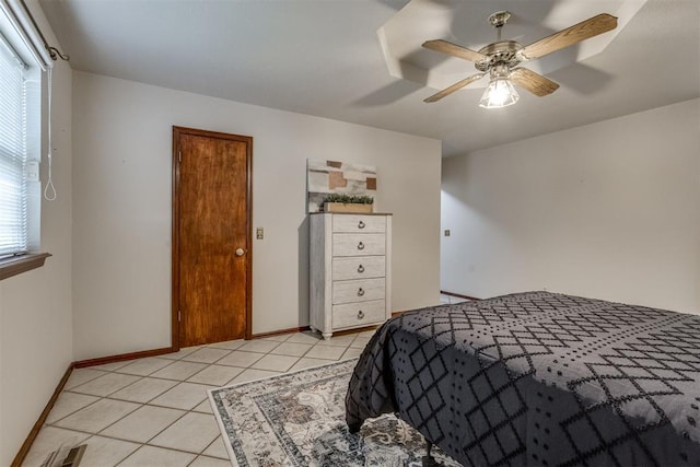 bedroom featuring light tile patterned floors, visible vents, baseboards, and a ceiling fan