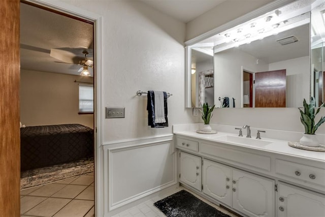 bathroom featuring tile patterned floors, vanity, and a ceiling fan