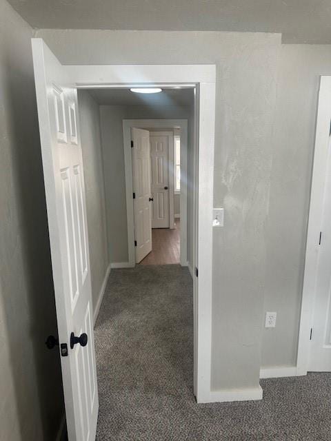 hall with baseboards and carpet