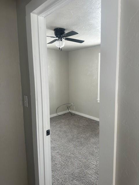 spare room featuring a ceiling fan, baseboards, carpet floors, and a textured ceiling