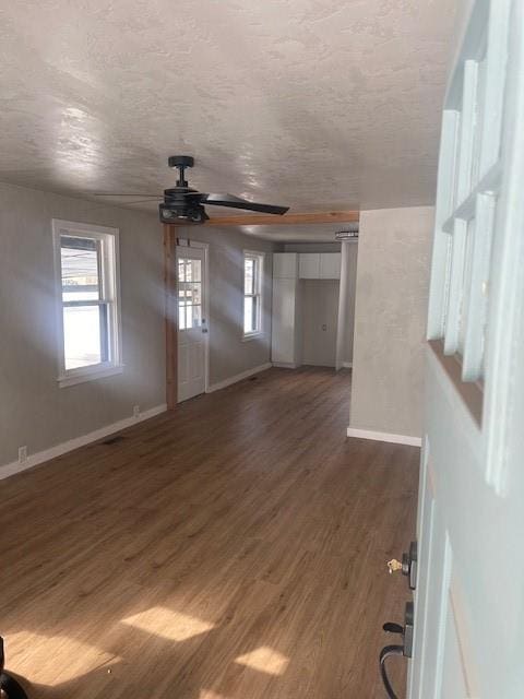 1214 E Cleveland Ave, Guthrie, OK 73044 - interior space with dark wood-style flooring, ceiling fan, baseboards, and a textured ceiling