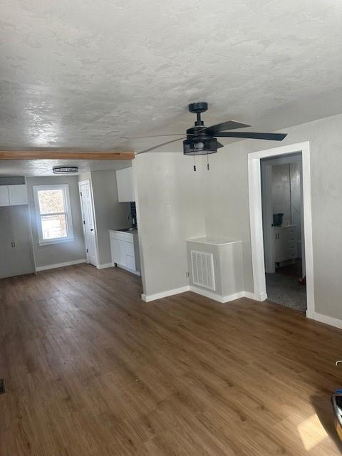 1214 E Cleveland Ave, Guthrie, OK 73044 - unfurnished living room featuring baseboards, ceiling fan, wood finished floors, and visible vents