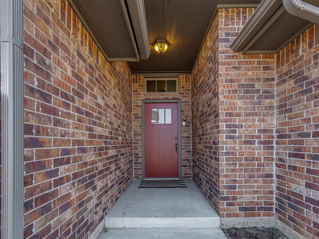 entrance to property with brick siding