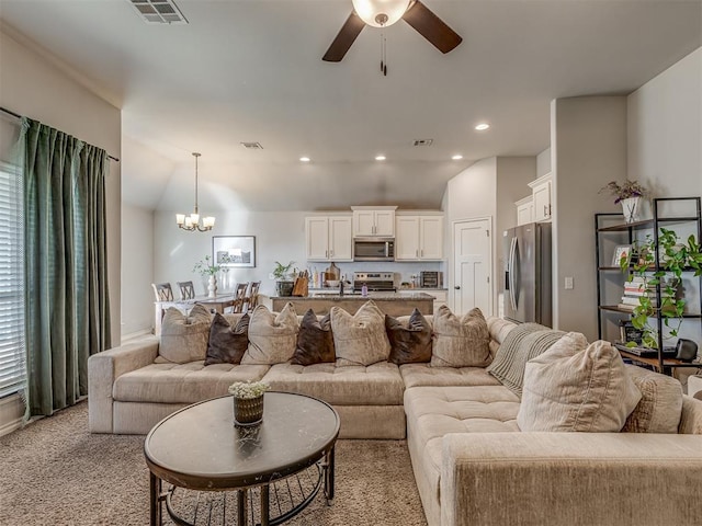 living room featuring recessed lighting, visible vents, light carpet, and ceiling fan with notable chandelier