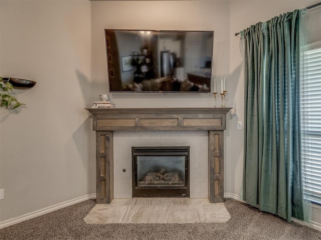 room details featuring baseboards, a brick fireplace, and carpet flooring