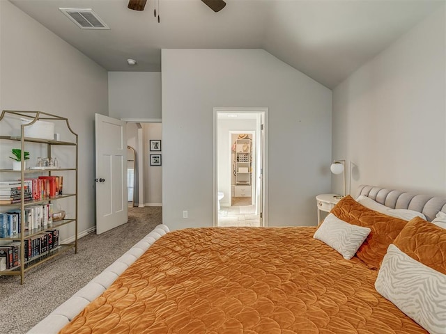 bedroom featuring visible vents, connected bathroom, vaulted ceiling, carpet flooring, and a ceiling fan