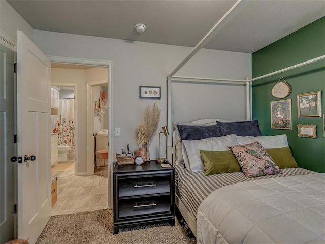 bedroom featuring carpet and ensuite bathroom