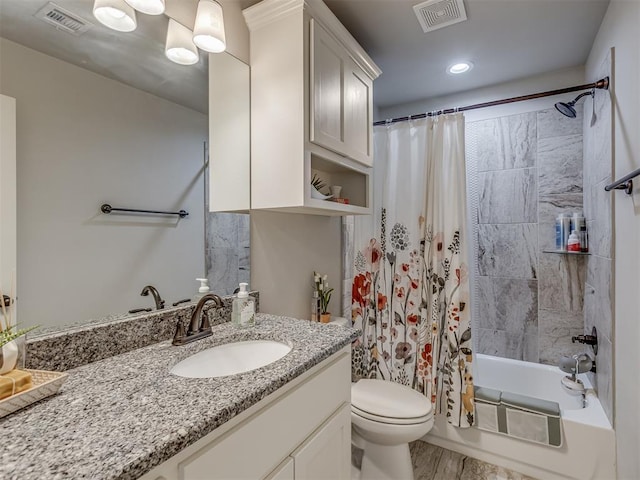 bathroom featuring visible vents, toilet, vanity, and shower / bath combo