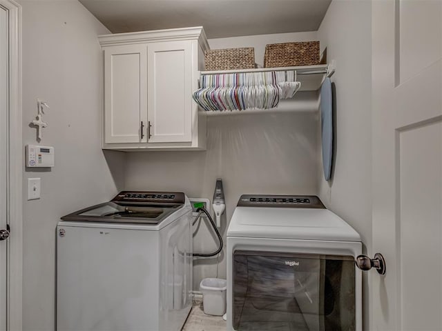 laundry room featuring cabinet space and washer and clothes dryer