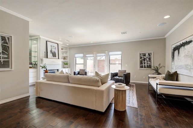 living room with dark wood finished floors, crown molding, baseboards, and visible vents