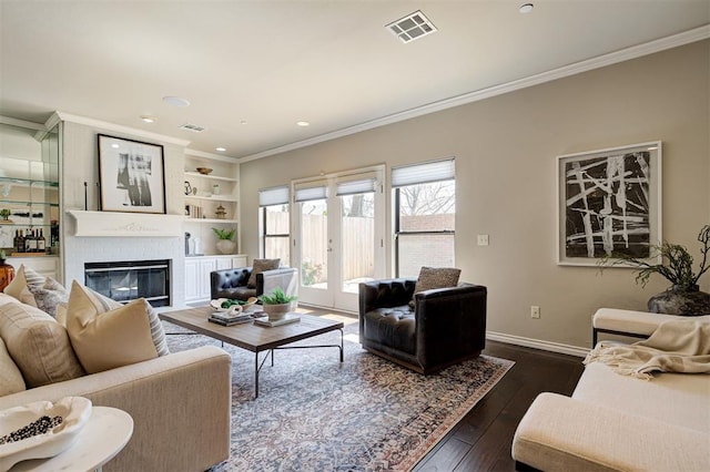 living area with visible vents, dark wood-style flooring, and ornamental molding