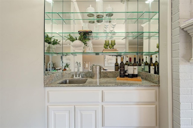 bar with wet bar and a sink