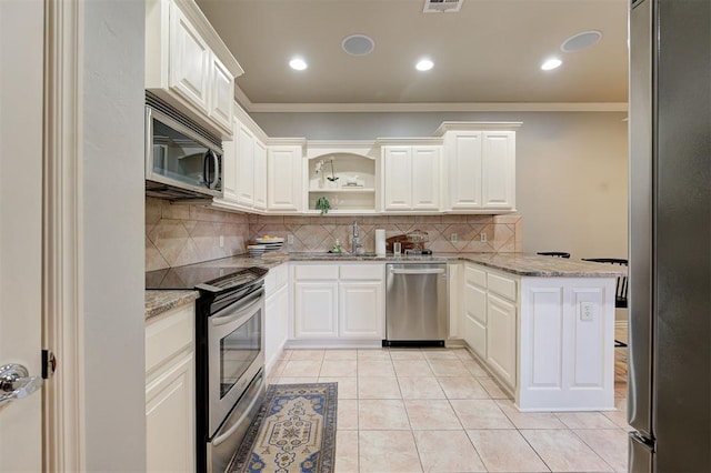 kitchen featuring crown molding, light stone countertops, light tile patterned floors, a peninsula, and stainless steel appliances