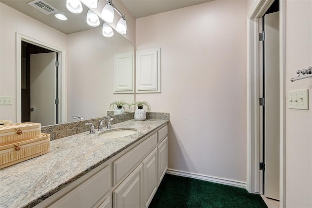 bathroom with visible vents, baseboards, and vanity