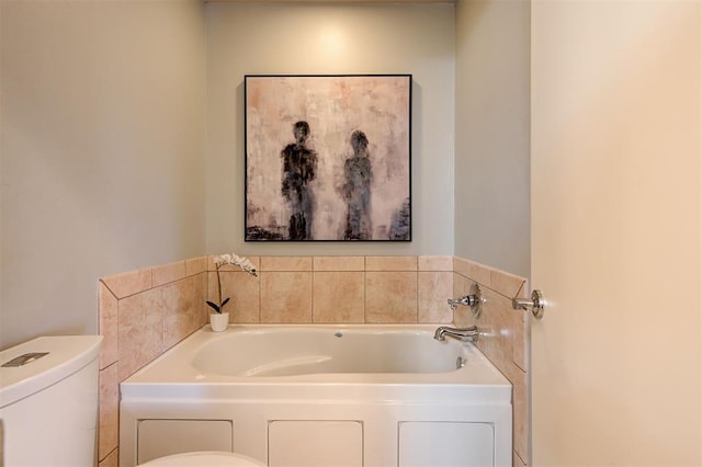 bathroom with a garden tub and toilet