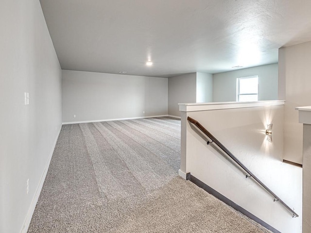 carpeted spare room with baseboards