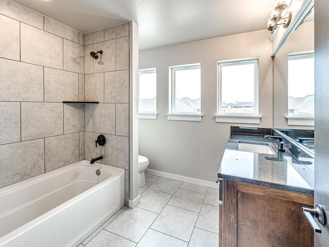 full bath with toilet,  shower combination, tile patterned flooring, baseboards, and vanity