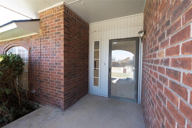 entrance to property with brick siding